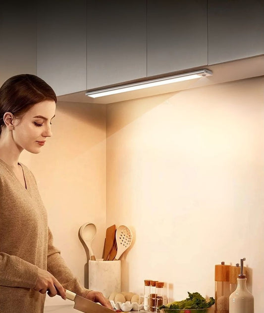 Woman cooking in bright kitchen with Vitroot extra long motion sensor lights.